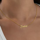 Gold necklace with 'Emma' pendant on a person's neck