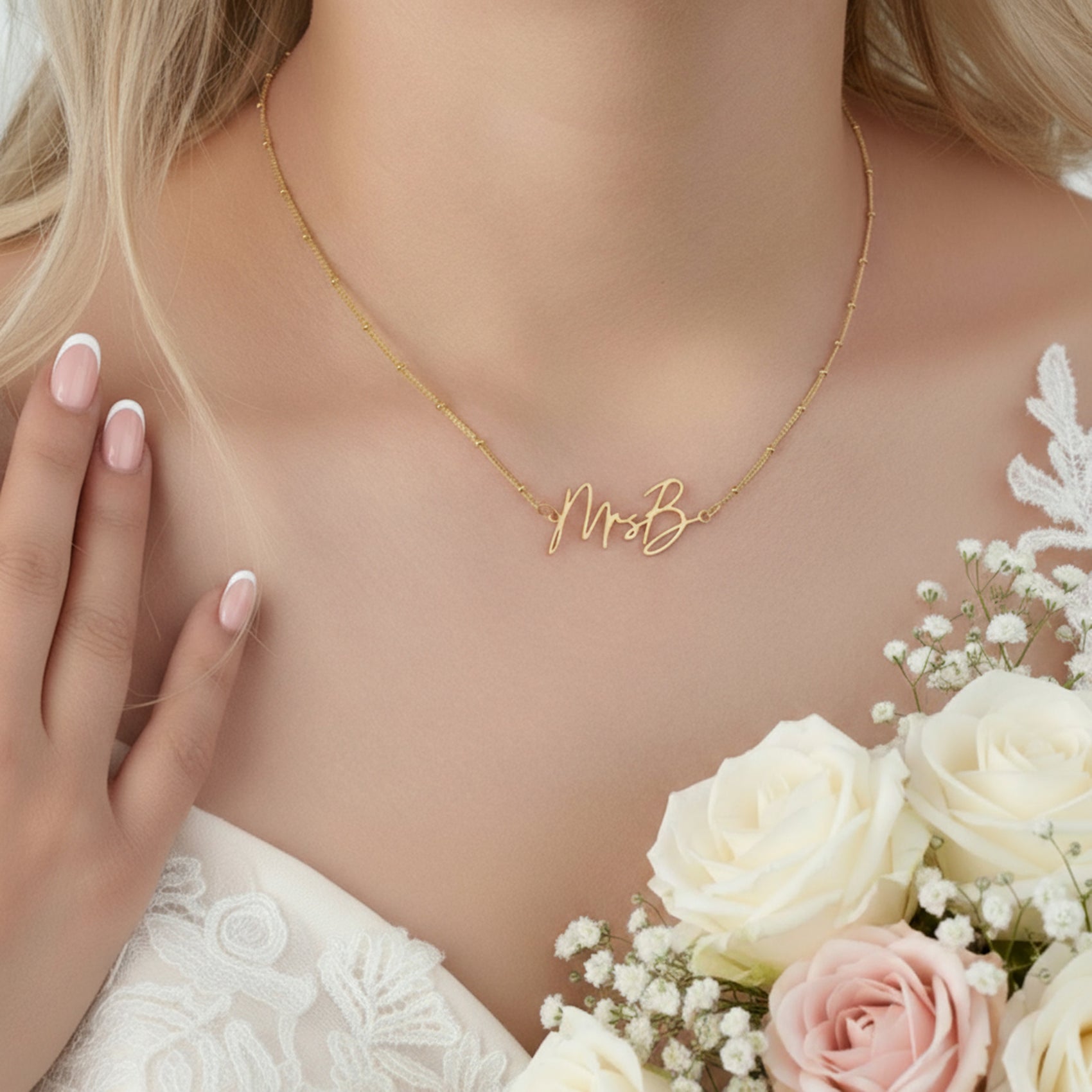Gold necklace with 'Mrs.' on a person wearing a wedding dress with flowers.